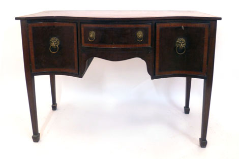 An 18th century style crossbanded mahogany serpentine fronted sideboard comprising a central
