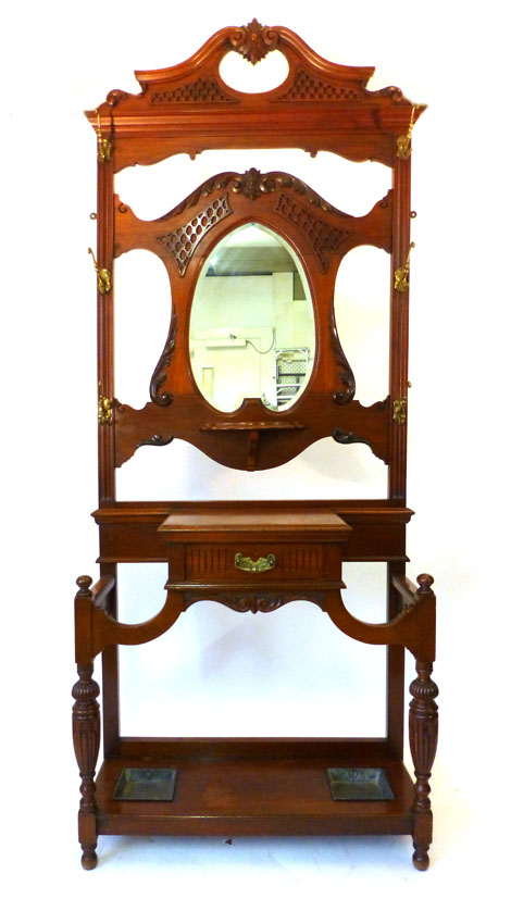 An Edwardian mahogany hall stand with a pierced and carved mirrored back above a base with single