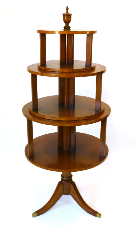 An 18th century style mahogany three tier buffet with a turned knop above three circular revolving