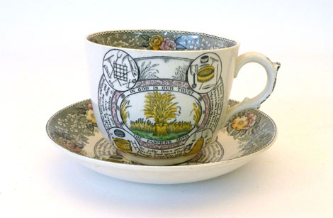 An Adams large tea cup and saucer, printed "In God is Our Trust the Farmers Arms" with floral