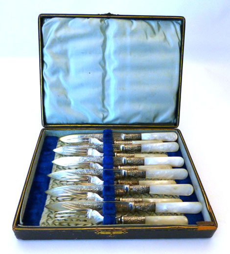 A Victorian cased set of six pairs of fish knives and forks with silver collars and mother of