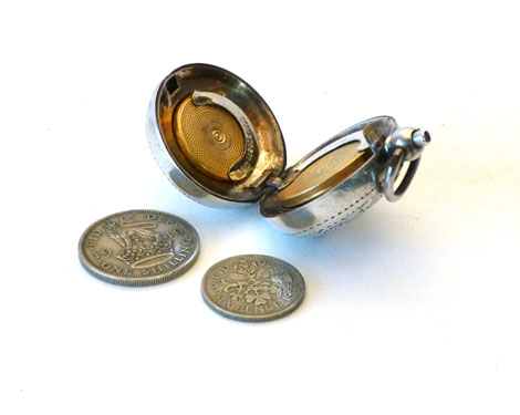 An Edwardian silver sovereign and half sovereign case of circular domed form with bright cut foliate