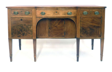 An 18th century style bow fronted mahogany sideboard with four drawers and three cupboard doors on