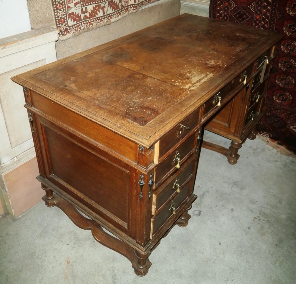 PEDESTAL DESK, early 20th century oak with tooled leather top, fitted six drawers around a kneehole,