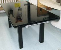 DINING TABLE, extendable black painted glass on square black supports with small extensions at