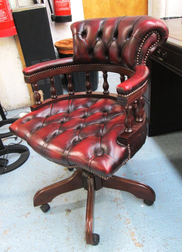 CAPTAINS CHAIR, mahogany and oxblood leather on castors, 62cm.