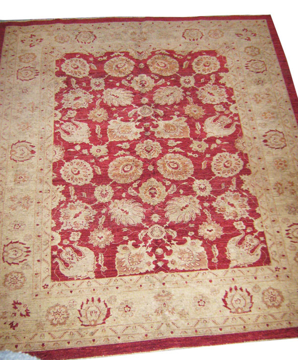 ZIEGLER DESIGN CARPET, of flowering vines on a red field within a pale contrasting border, 280cm x