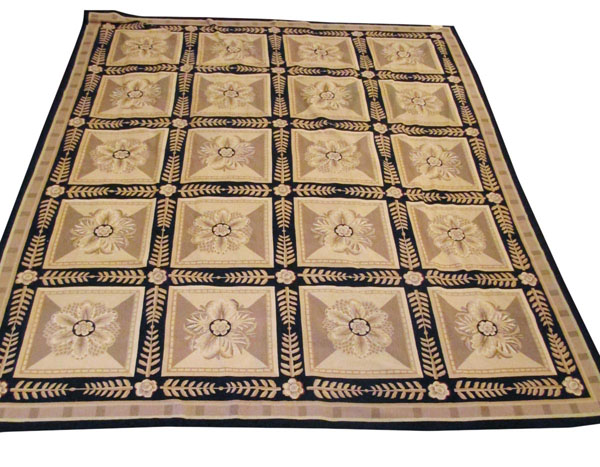 AUBUSSON STYLE CARPET, of multiple panels centred with flower heads within noir field with palm leaf