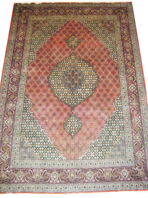 FINE TABRIZ CARPET, 298cm x 204cm, the salmon coloured field, ivory pendant medallion and pale