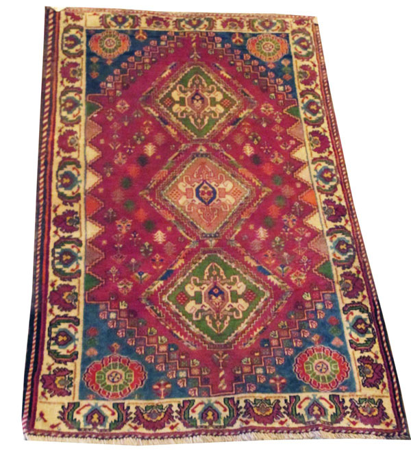 QASHQAI RUG, of three connecting diamonds on red field with turquoise spandrels within ivory border,