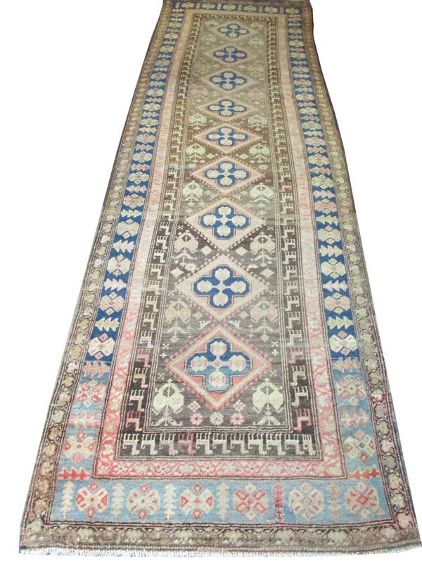 KARABAGH RUNNER, 339cm x 104cm, North West Persia, the dark brown field of lozenge motifs within