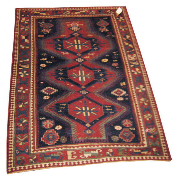 ANTIQUE KAZAK RUG, 240cm x 171cm, circa 1910, the Prussian blue field decorated with connecting