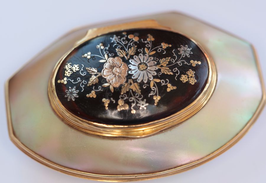 A mounted mother of pearl box with pique work lid the shaped oval carved mother of pearl box, with