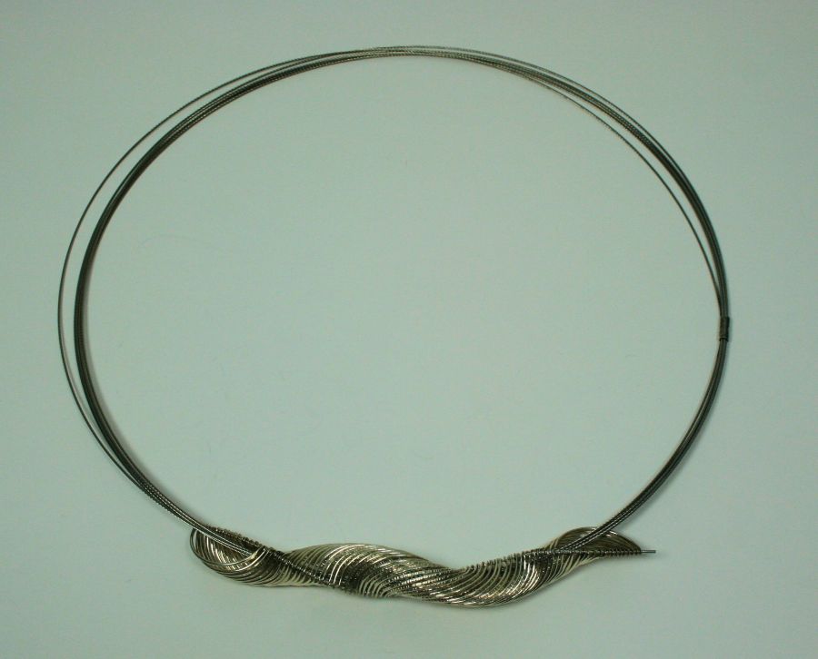 JENNY DEANS - `Curving Round` necklace composed of stainless steel and white metal, with woven