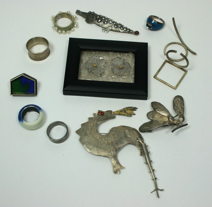 A collection of items to include a Paul Preston white metal crocodile brooch; a white metal ring