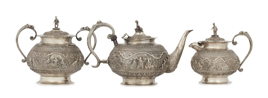 An Indian three piece tea set unmarked, comprising teapot, covered twin handled sugar bowl, and