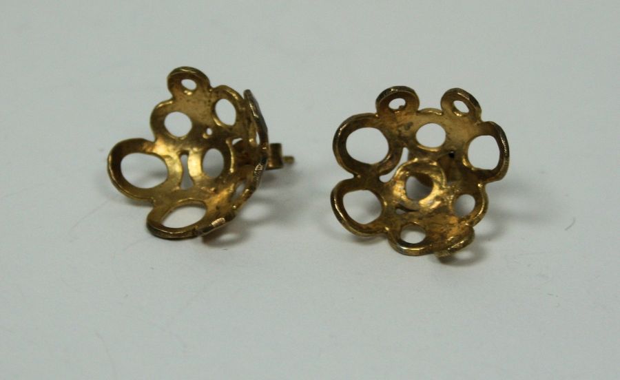 MIYA HAYES - A pair of yellow metal earrings composed of numerous pierced circles in an abstract