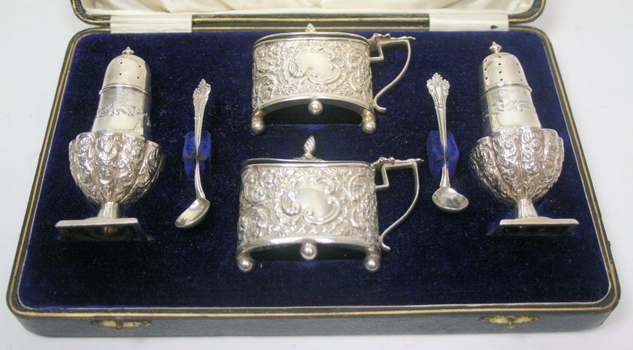 A cased cruet Birmingham 1900, comprising a pair of baluster pepper pots, oval drum mustards and two