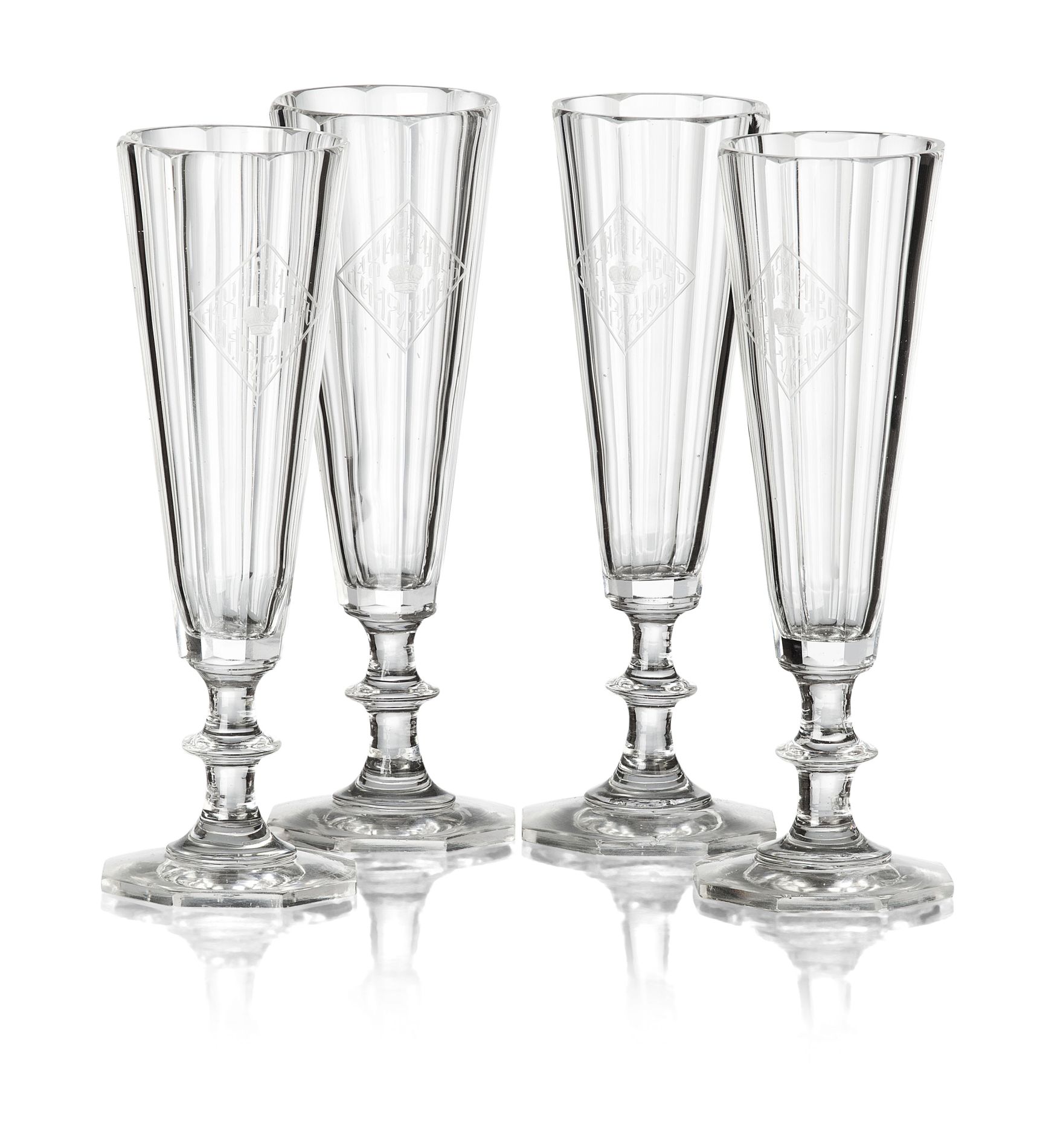 FOUR RUSSIAN IMPERIAL GLASS WORKS CHAMPAGNE FLUTES FROM A BANQUET SERVICE 19TH CENTURY of facetted