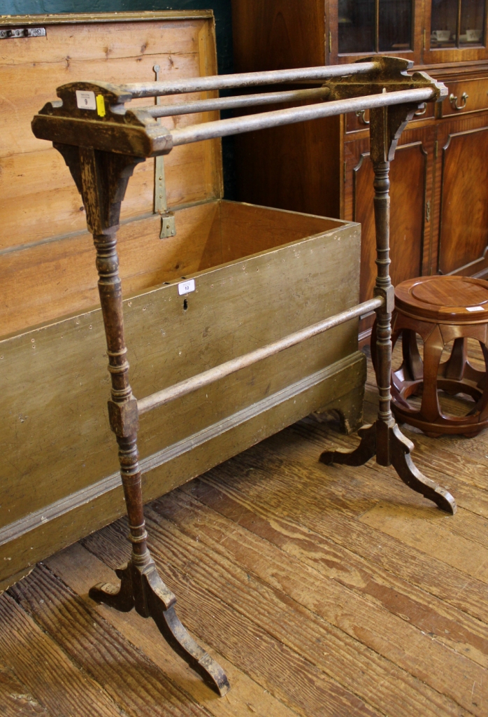 An early 20th century pine towel holder with four rails, supported on turned trestle supports and