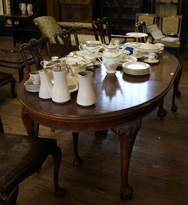 A Georgian style mahogany `D` end extending dining table with shaped top, carved knuckles on