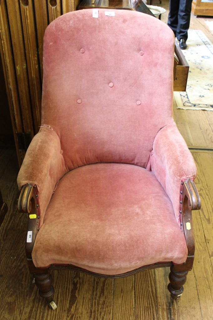 An early Victorian mahogany button back library or drawing room chair with fabric upholstered shaped