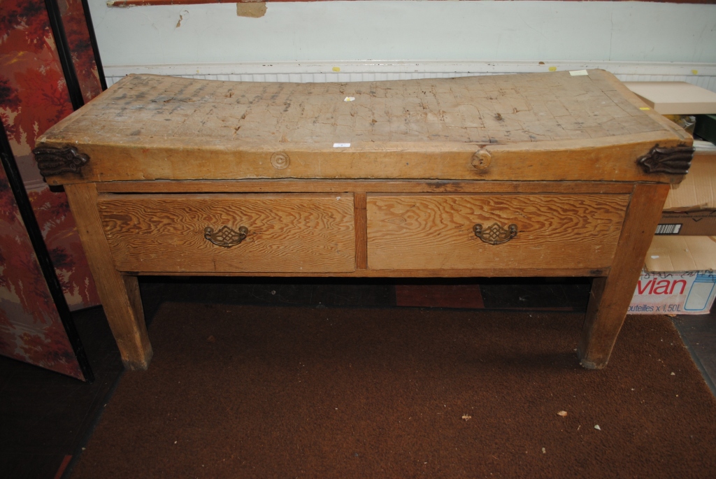 An early 20th century oblong shaped butchers block with hard wood top with two pine drawers under