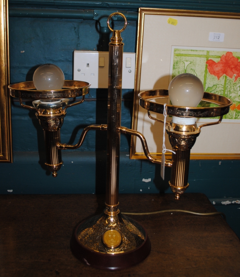 A mid 20th century circular brass desk lamp with fluted central support with shades missing