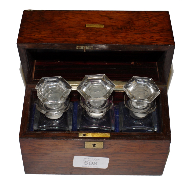 A Regency brass banded rosewood box containing three glass scent bottles