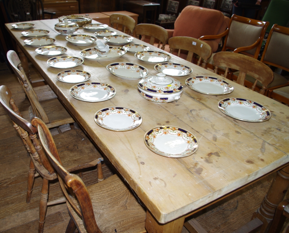 A large 19th century refectory table of oblong shape with turned legs and stretcher support, 282