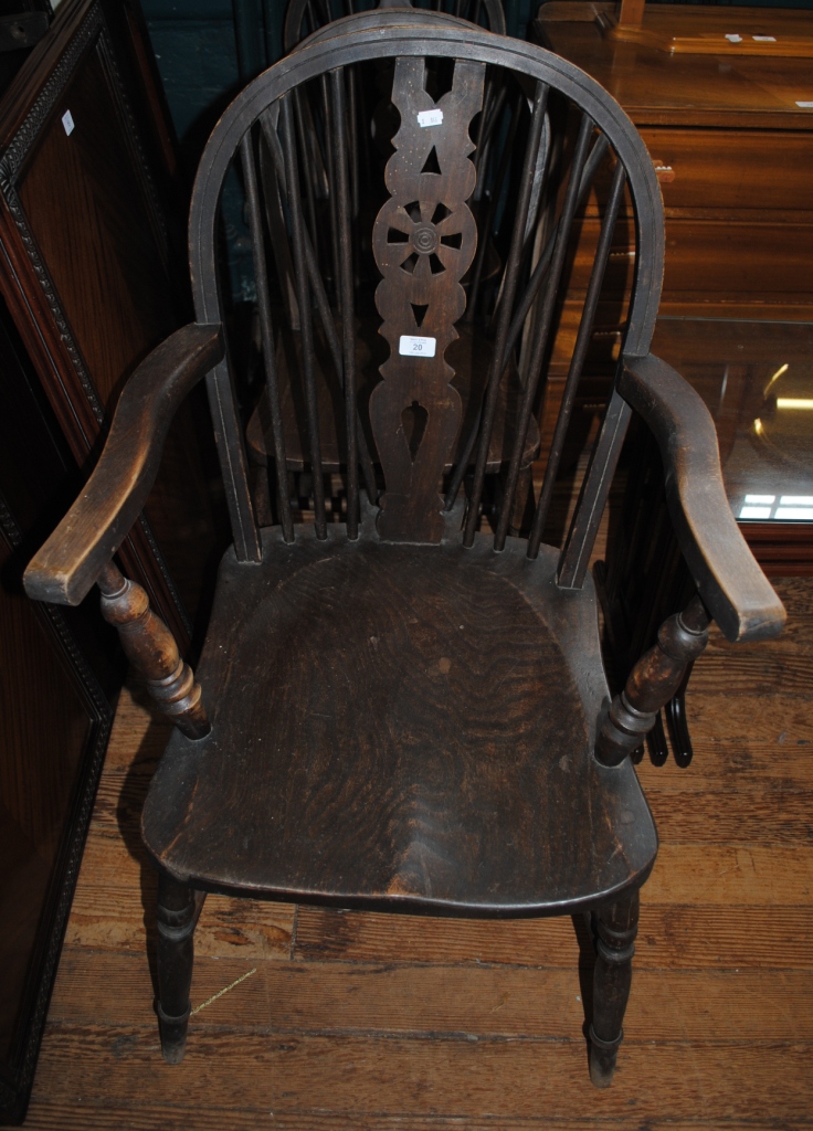 Two 19th century oak stained Windsor style kitchen chairs, together with a similar carver with