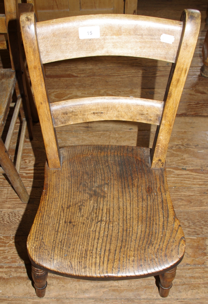 A 19th century hardwood child`s chair with elm seat raised on turned legs and stretcher support