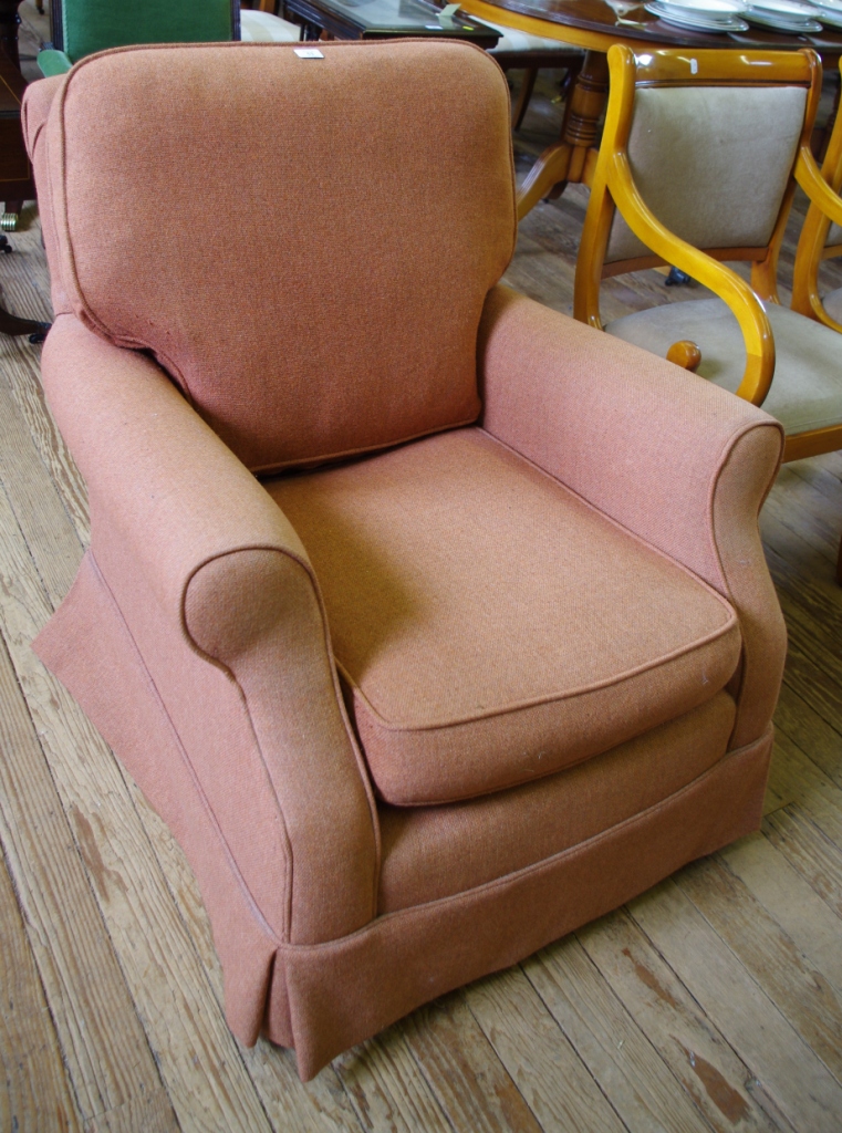 A Victorian style upholstered armchair with turned wooden legs