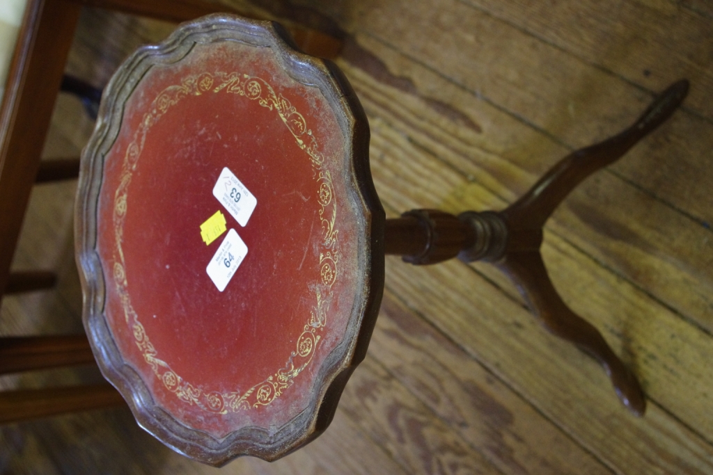 A Georgian style mahogany circular wine or side table with pie crust border, leather inset supported