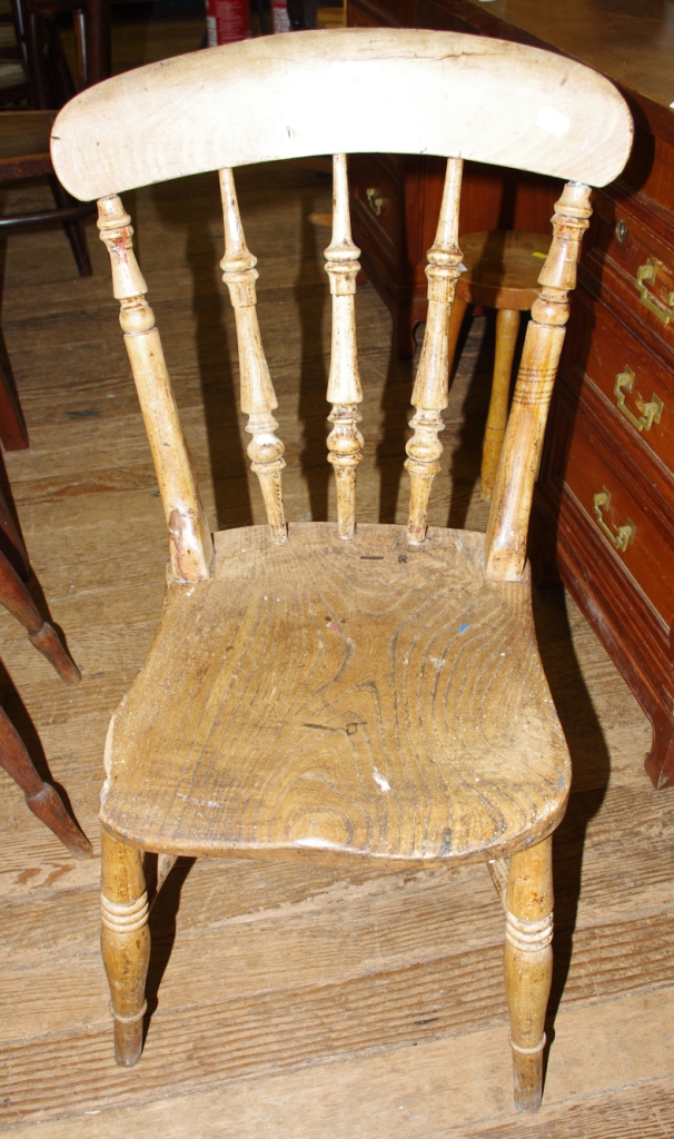 Three 19th century hardwood dining chairs with shaped top rails, spindle supports with elm seats,