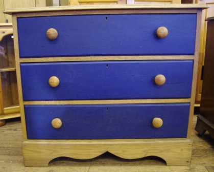 An oak and painted chest of three drawers with shaped top and wavy rim plinth measuring 80x92cm