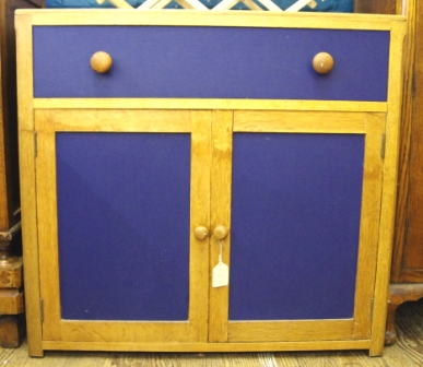 An oblong pine cupboard with painted central drawer and doors, measuring 74x84cm