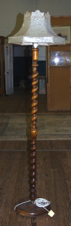 A Victorian mahogany floor lamp with rope twist column on circular base complete with shade