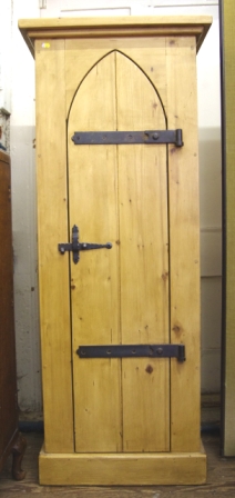 A tall oblong cupboard with Gothic style door, the shelved interior with metal fittings measuring