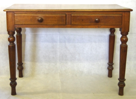 A Victorian mahogany side table with shaped top, two drawers under and turned legs