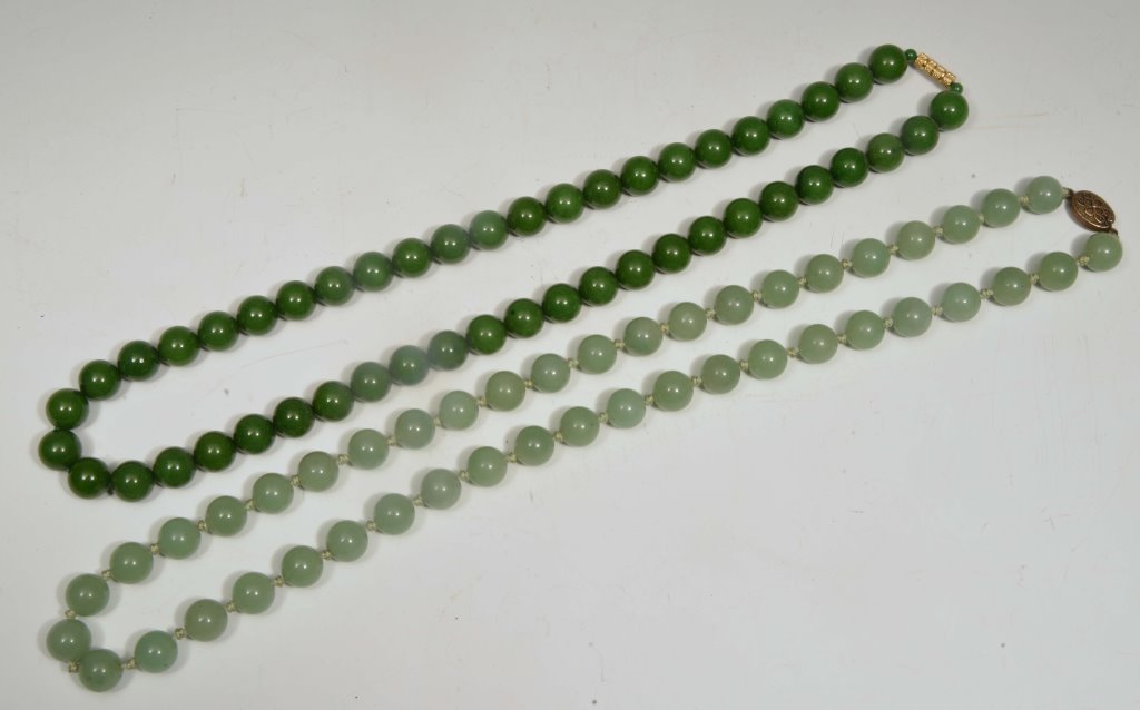 A CHINESE GREEN JADE NECKLACE and one other spinach jade necklace (2)