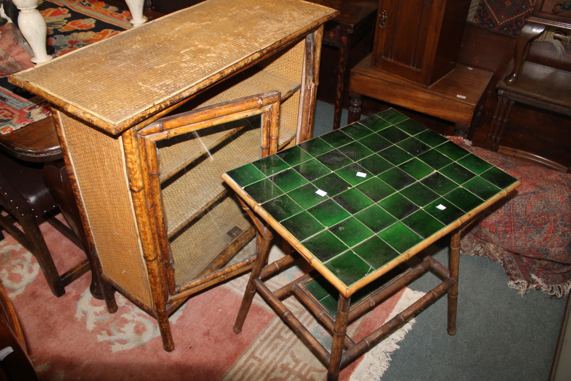 A BAMBOO DISPLAY CABINET fitted two shelves, 94cm, and two bamboo occasional tables, one with