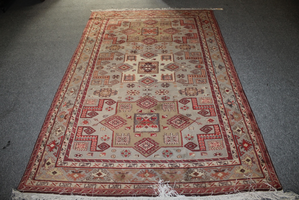 A PAKISTAN WOOL LARGE RUG with three medallions and overall geometric decoration, 247cm x 160cm