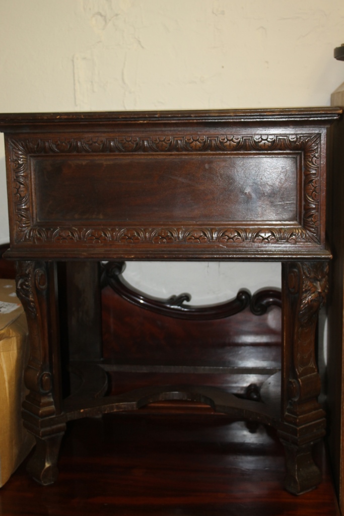 AN ITALIANATE CARVED COCKTAIL CABINET, the front supports with mask decoration, 66cm wide