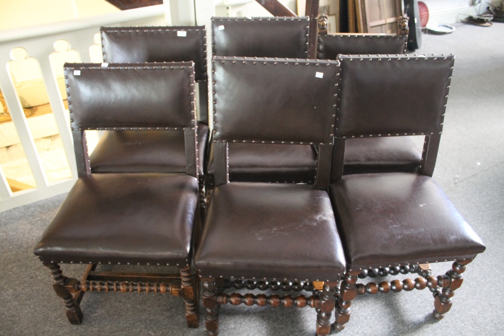 A SET OF FIVE AND ONE OAK AND LEATHER CAROLEAN STYLE DINING CHAIRS, each with brass studded mounts