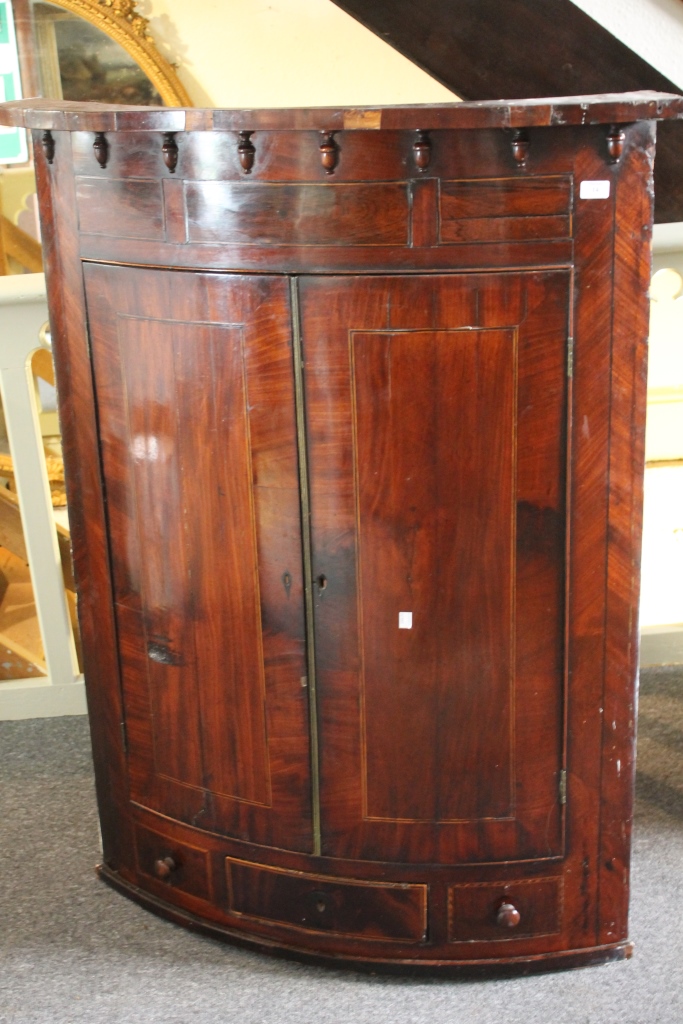 A LARGE VICTORIAN BOW FRONT MAHOGANY CORNER CUPBOARD with boxwood line inlay, 97cm x 130cm