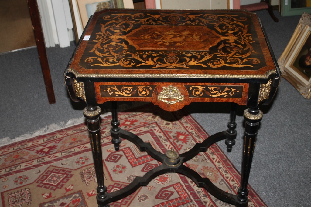 A 19TH CENTURY AMBOYNA AND EBONISED MARQUETRY CENTRE TABLE with two drop leaves, the central panel