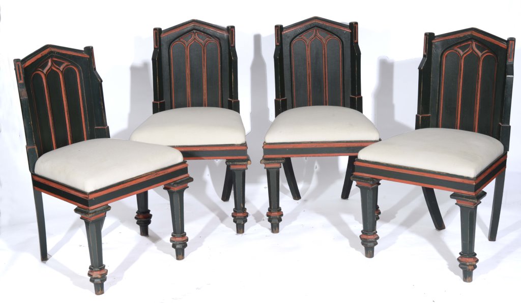 A SET OF FOUR PAINTED GOTHIC STYLE DINING CHAIRS, each ogee arched back and upholstered drop in