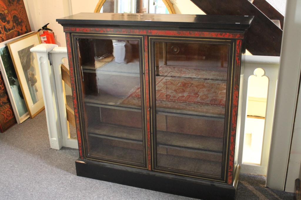 A 19TH CENTURY EBONISED AND TORTOISESHELL BOOKCASE with plain glazed panel doors inlaid in brass, on