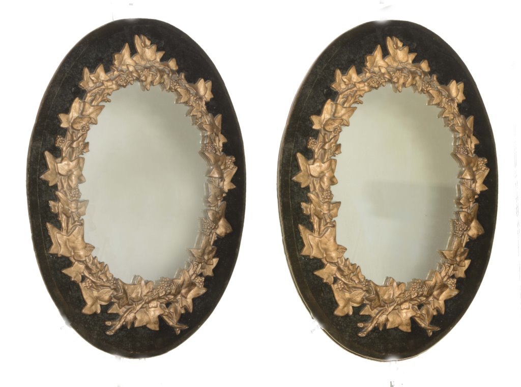 A PAIR OF VICTORIAN GILT METAL WALL MIRRORS mounted on velvet, each in the form of vine and vine